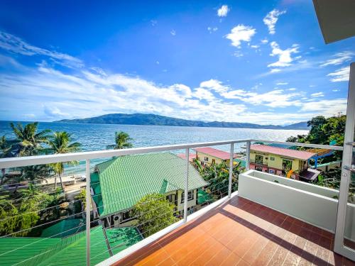 a balcony with a view of the water at Lovely Beach House in Anilao in Mabini