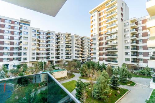an apartment complex with tall buildings and a courtyard at Luxury Pipera in Voluntari