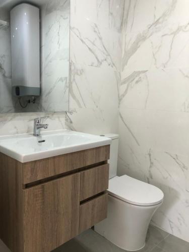 a bathroom with a sink and a toilet at VC Alojamentos in Seia