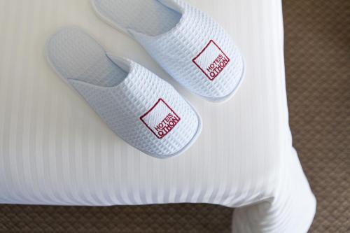 a pair of white shoes with red labels on them at Rio Othon Palace in Rio de Janeiro