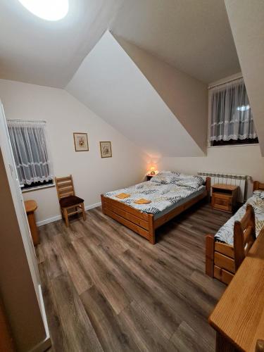 a bedroom with two beds and a table and chairs at Willa Dniestrzanka in Krynica Zdrój
