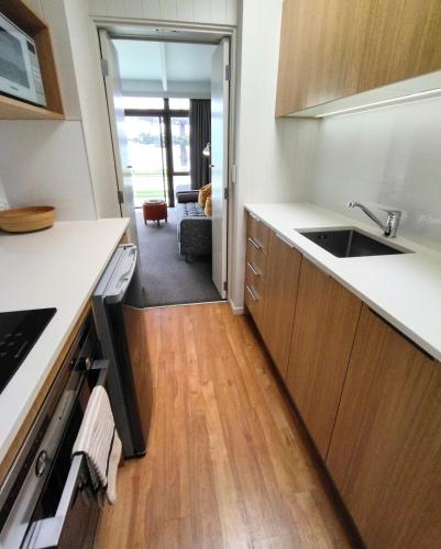 a kitchen with a sink and a counter top at Whispering Sands Beachfront Motel in Gisborne