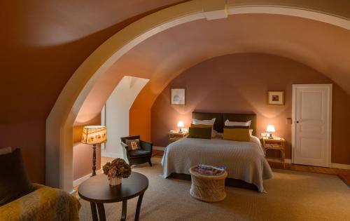 a bedroom with a bed and an archway at Chateau des Grotteaux Près Chambord in Chambord