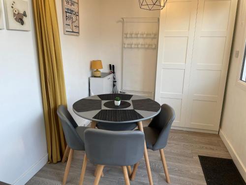 a dining room with a black table and chairs at Pebbles 144 South Shore 2 bed chalet 2 dog friendly, sleeps 4 in Bridlington