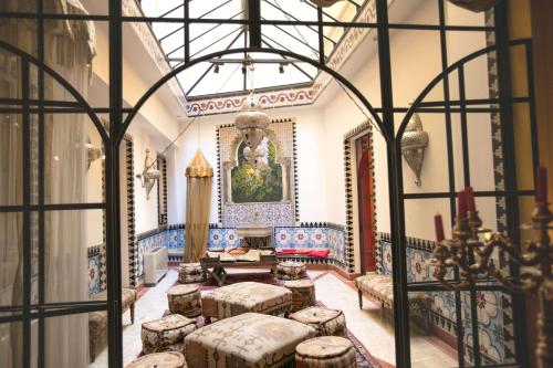 a living room with tables and stools in a building at Best Western Ai Cavalieri Hotel in Palermo