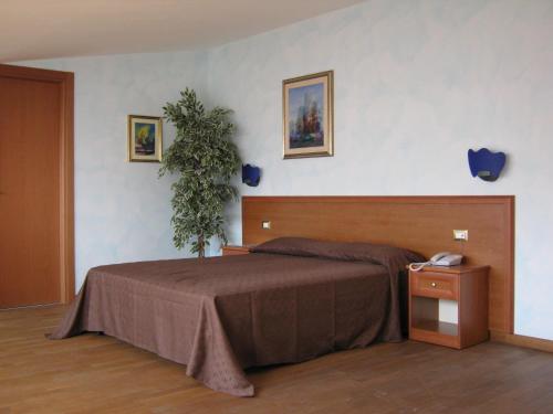 En eller flere senge i et værelse på Hotel Villa d'Evoli