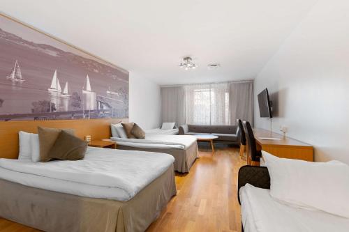 a hotel room with two beds and a tv at Sure Hotel by Best Western City Jonkoping in Jönköping