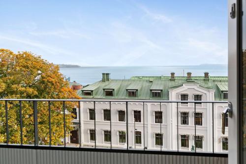 a large white building with a green roof at Sure Hotel by Best Western City Jonkoping in Jönköping