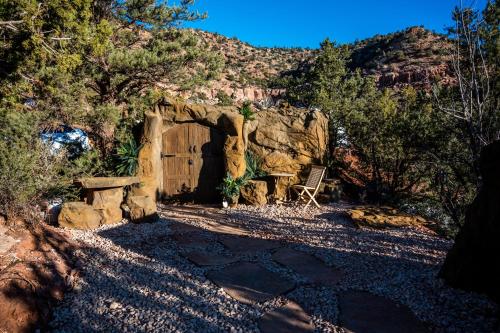 a cave with a wooden door in a rocky field at Zion Glamping Adventures in Hildale