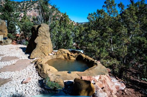 a small pool of water in a rock formation at Zion Glamping Adventures in Hildale