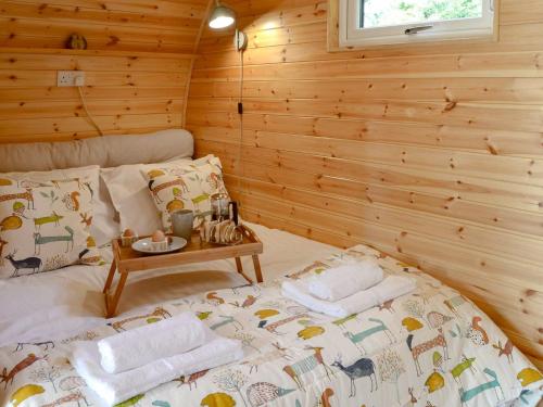 a bedroom with a bed in a wooden cabin at Park View - Ukc4925 in Roydon