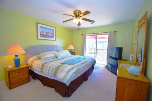 a bedroom with a bed and a ceiling fan at Club Ocean Villas II 19 condo in Ocean City