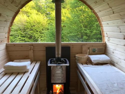 an inside view of a sauna with a wood stove at Leśniczówka domek sauna jeziorko w lesie na wyłączność in Straszydle