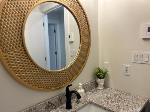 a bathroom with a sink with a mirror at City Modern Apartment in Charlottetown