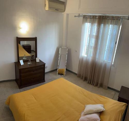 a bedroom with a bed and a mirror and a dresser at Cozy place in the heart of rabat in Rabat