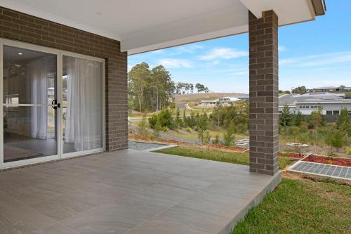a patio with a view of a house at 4 bedroom home with theatre room, close to CBD and beaches. in Sunshine Bay