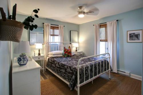 a bedroom with a bed and two windows at Renovated, Quiet, and 1/2 Mile to BEACH in Cape May