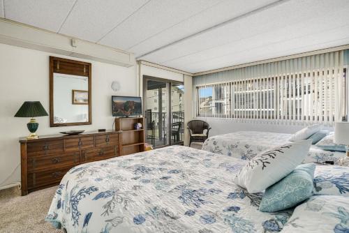 a bedroom with two beds and a window at Oceana II 109 condo in Ocean City