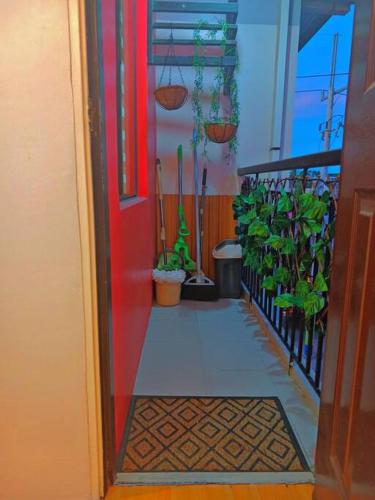 a door leading to a hallway with potted plants at Minamalist Condo Staycation in Imus