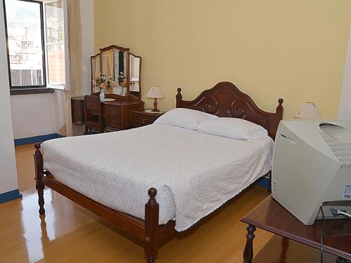 Кровать или кровати в номере Pensao Astoria