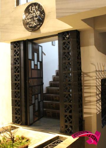a entrance to a building with a door and stairs at La Curva Apartamentos in Cali