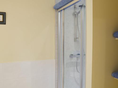 a shower with a glass door in a bathroom at Lakeland View in Scotforth