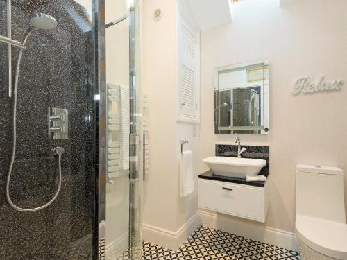 a bathroom with a shower and a sink at Homestead Cottage in Benniworth