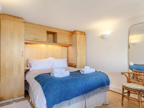 a bedroom with a large bed with towels on it at Studio Sea Urchin in Carbis Bay