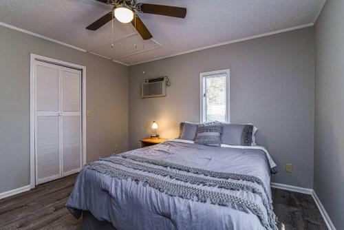 a bedroom with a bed and a ceiling fan at Cozy Mtn getaway. 11 miles to downtown Asheville in Asheville