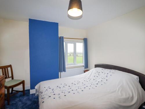 a bedroom with a white bed and a window at The Manor House at Kenwick Lodge in Ellesmere