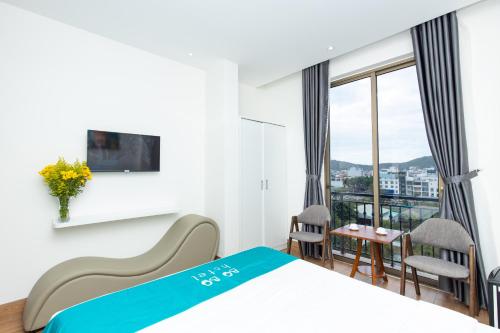 a hotel room with a bed and a window at BOBO Boutique Hotel in Vung Tau