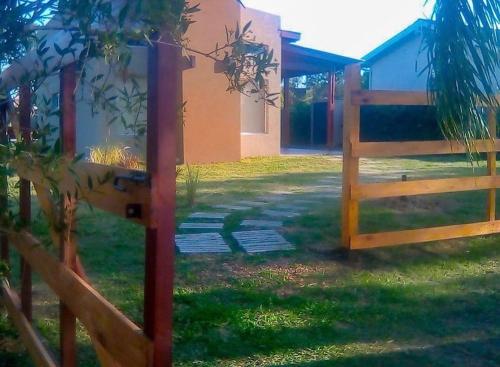 a fence and a gate in front of a house at Pinares del Norte in Federación