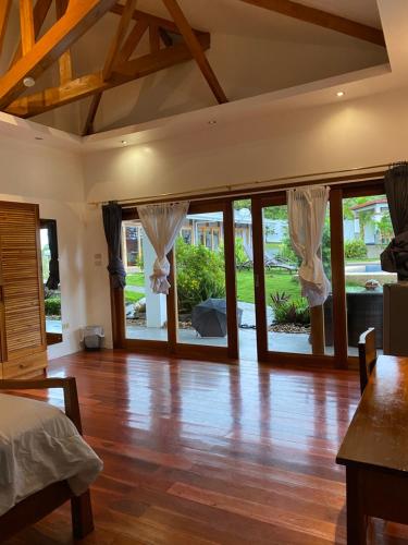 a bedroom with sliding doors to a garden at Villa MountainView Guesthouse in Dimiao