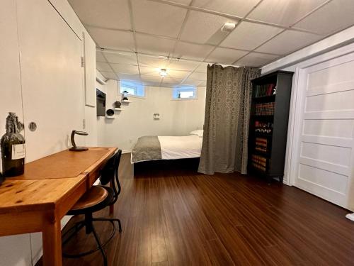 a room with a desk and a bed in a room at Hiltz House Cellar Suite Near Halifax Ferry in Halifax