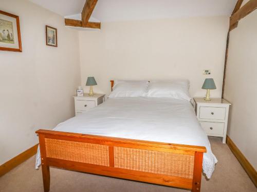 a bedroom with a large bed with two night stands at The Barn in Ellesmere