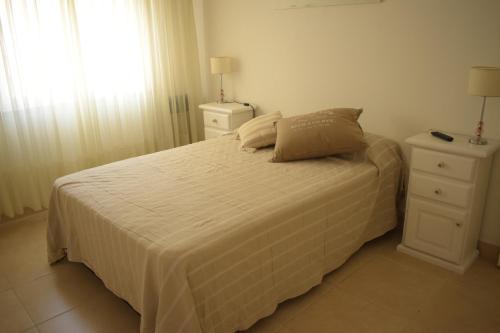 a bedroom with a bed with two night stands and a window at DTO en Mar del Plata para 6 o 4 Personas in Mar del Plata