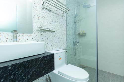 a bathroom with a toilet and a sink and a shower at BOBO Boutique Hotel in Vung Tau