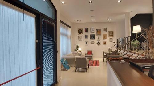 a living room with a large window and a couch at Hotel Rawson 3840 in La Lucila