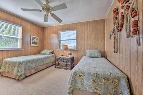 a bedroom with two beds and a ceiling fan at Fernandina Cottage Deck, Direct Beach Access in Fernandina Beach
