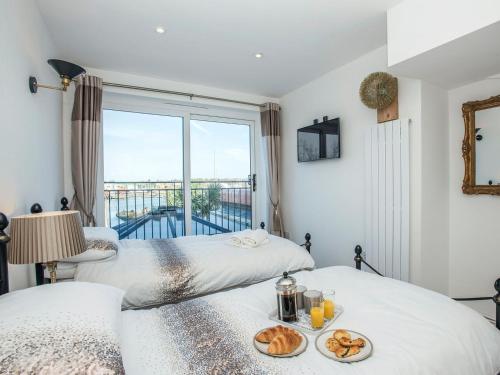 two beds in a room with a window at The Shipwreck in Oulton