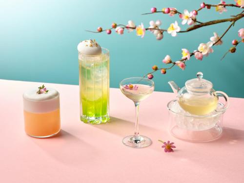 a pink table with two bottles and a glass at Four Seasons Hotel Singapore in Singapore