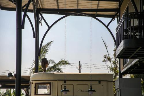 a person is standing on top of a train at Nex Station Kanchanaburi in Kanchanaburi