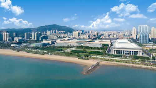 an aerial view of a city with a beach and buildings at Xiamen International Seaside Hotel-Free Welcome Fruit& Mini Bar in Xiamen
