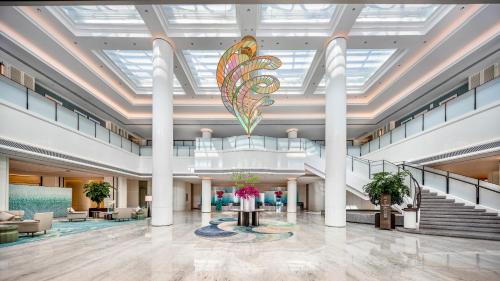 a lobby with a large butterfly hanging from the ceiling at Xiamen International Seaside Hotel-Free Welcome Fruit& Mini Bar in Xiamen