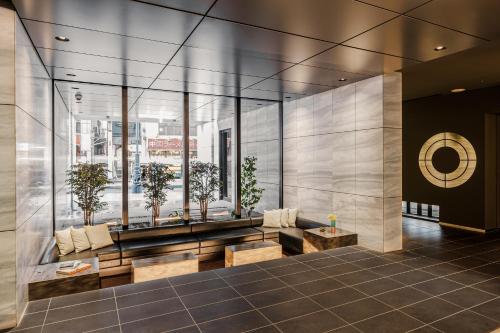 a lobby of a building with benches and windows at OMO3 Tokyo Akasaka by Hoshino Resort in Tokyo