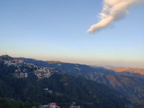 a view of a city in the mountains at The Oaktree House in Shimla