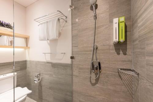 a bathroom with a shower with a glass door at Juno Tanah Abang Jakarta in Jakarta