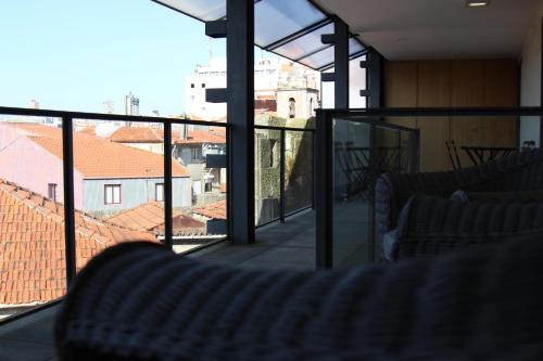 a balcony with chairs and a view of a city at Casas do Teatro in Porto