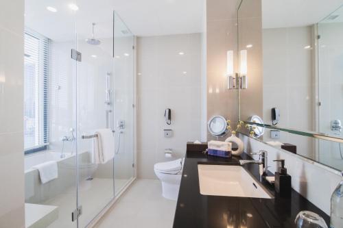 a bathroom with a sink and a toilet and a shower at 137 Pillars Residences Bangkok in Bangkok