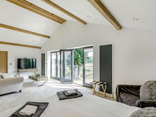 a living room with a bed and a couch at Howell Hall Barn in Howell